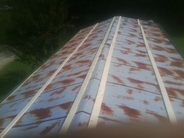 Rusted metal roof panels with new wood purlins before replacement — Storm Damage Roof Repair in Whitestown by Roofing Brothers